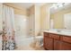 Cozy bathroom featuring shower-tub combo, wood vanity, and tile flooring at 620 Willow Haven Way, Suwanee, GA 30024