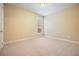 Bedroom with neutral carpet, cream walls, and a window at 620 Willow Haven Way, Suwanee, GA 30024