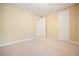 Empty bedroom with neutral carpeting and two doors at 620 Willow Haven Way, Suwanee, GA 30024