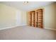 Bedroom featuring built-in bookshelves and neutral carpet at 620 Willow Haven Way, Suwanee, GA 30024