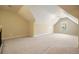 Upstairs bonus room with neutral carpeting, window, and freshly painted walls at 620 Willow Haven Way, Suwanee, GA 30024