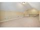 Large bonus room has neutral carpeting, fresh paint, and staircase at 620 Willow Haven Way, Suwanee, GA 30024