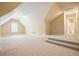 Expansive bonus room featuring neutral carpet, natural light, and access to bathroom at 620 Willow Haven Way, Suwanee, GA 30024