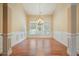 Elegant dining room with hardwood floors, chandelier, wainscoting, and large windows at 620 Willow Haven Way, Suwanee, GA 30024