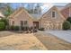 Charming brick home featuring a two-car garage and well-maintained front yard landscaping at 620 Willow Haven Way, Suwanee, GA 30024