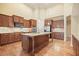 Modern kitchen with a large granite island, updated appliances, and hardwood flooring at 620 Willow Haven Way, Suwanee, GA 30024