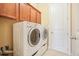 Laundry room with full-sized, front load washer and dryer, and ample cabinetry at 620 Willow Haven Way, Suwanee, GA 30024