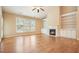 Bright living room with hardwood floors, fireplace, built-in shelves, and large windows at 620 Willow Haven Way, Suwanee, GA 30024