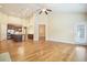 Open-concept living space with hardwood floors, stainless appliances, kitchen island, and ample natural light at 620 Willow Haven Way, Suwanee, GA 30024