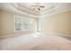 Bright main bedroom with a ceiling fan, large window, and neutral color scheme at 620 Willow Haven Way, Suwanee, GA 30024