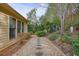 Landscaped yard with winding stone path, shrubs, trees, and lawn ornaments at 620 Willow Haven Way, Suwanee, GA 30024