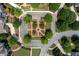 Aerial view of a neighborhood featuring homes surrounding a beautifully landscaped traffic circle at 1075 Lancaster Sq, Roswell, GA 30076
