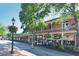 Street view of Roswell Flowers and other businesses with outdoor seating and apartments above at 1075 Lancaster Sq, Roswell, GA 30076