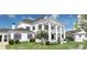 Beautifully designed home with a columned porch, landscaping, and an inviting entrance at 1075 Lancaster Sq, Roswell, GA 30076