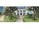 Elegant home featuring a landscaped front yard, stone pathway, and classic architectural design at 1075 Lancaster Sq, Roswell, GA 30076