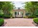 View of a gazebo at the end of a brick path overlooking a stream or pond at 1075 Lancaster Sq, Roswell, GA 30076