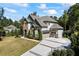 Spacious two-story home featuring a long driveway, attached two-car garage, and mature trees at 3111 Old Thompson Mill Rd, Buford, GA 30519