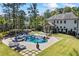 Expansive backyard with a stunning pool, lounge chairs, and manicured landscaping at 3111 Old Thompson Mill Rd, Buford, GA 30519