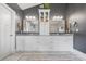 Double vanity bathroom with granite countertop and stylish mirrors at 3111 Old Thompson Mill Rd, Buford, GA 30519