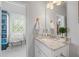 Bright bathroom has a vanity with a granite countertop and ample storage at 3111 Old Thompson Mill Rd, Buford, GA 30519