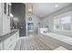 Bright bathroom features double vanities, granite countertop, glass shower and separate tub at 3111 Old Thompson Mill Rd, Buford, GA 30519