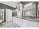 Double vanity bathroom with granite countertop, stylish mirrors and great lighting at 3111 Old Thompson Mill Rd, Buford, GA 30519