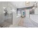 Well-lit bathroom featuring double vanities, granite countertops, tiled floor, glass enclosed shower, and a soaking tub at 3111 Old Thompson Mill Rd, Buford, GA 30519
