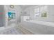 Spacious bathroom features large tub, glass enclosed shower and lots of natural light at 3111 Old Thompson Mill Rd, Buford, GA 30519