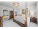 Comfortable primary bedroom with a four poster bed and decoratively painted accent wall at 3111 Old Thompson Mill Rd, Buford, GA 30519