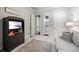Inviting room with a cabinet television, soft gray sofa, neutral walls, and wood floors at 3111 Old Thompson Mill Rd, Buford, GA 30519