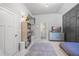 Stylish bedroom featuring a blue dresser, gray accent wall, and carpet at 3111 Old Thompson Mill Rd, Buford, GA 30519
