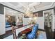 Open formal dining room featuring a stunning chandelier, coffered ceiling and open access to other rooms at 3111 Old Thompson Mill Rd, Buford, GA 30519