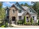 Charming two-story home featuring a combination of stone and siding, complemented by professionally landscaped grounds at 3111 Old Thompson Mill Rd, Buford, GA 30519