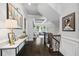 Hallway featuring dark floors, staircase, wainscoting and natural light at 3111 Old Thompson Mill Rd, Buford, GA 30519