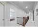 Bright hallway features hardwood floors, paneled walls, and access to bedrooms at 3111 Old Thompson Mill Rd, Buford, GA 30519