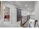 Hallway with wood staircase, barn door, carpet and iron railing at 3111 Old Thompson Mill Rd, Buford, GA 30519