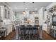 Modern eat-in kitchen with stainless steel appliances, island with seating, and white cabinets at 3111 Old Thompson Mill Rd, Buford, GA 30519