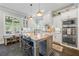 Open kitchen featuring a spacious island, stainless steel appliances, white cabinetry, and bar stool seating at 3111 Old Thompson Mill Rd, Buford, GA 30519