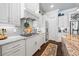 Gourmet kitchen with stainless appliances, granite countertops, white cabinets, and stylish range hood at 3111 Old Thompson Mill Rd, Buford, GA 30519