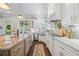 Beautiful open kitchen with island, stainless steel appliances, granite countertops, and white cabinetry at 3111 Old Thompson Mill Rd, Buford, GA 30519
