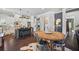 Eat-in kitchen with an island featuring countertop seating, stainless steel appliances, and wooden table at 3111 Old Thompson Mill Rd, Buford, GA 30519
