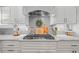 Close-up of the kitchen featuring granite countertops, stainless steel appliances, and crisp white cabinetry at 3111 Old Thompson Mill Rd, Buford, GA 30519