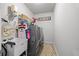 Efficient laundry room has modern appliances, a sink, and storage shelves for convenience at 3111 Old Thompson Mill Rd, Buford, GA 30519