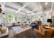 Spacious living room with coffered ceilings, fireplace, hardwood floors and a large sectional sofa at 3111 Old Thompson Mill Rd, Buford, GA 30519