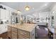 Open-concept living space with hardwood floors leading into the kitchen and main living room with fireplace at 3111 Old Thompson Mill Rd, Buford, GA 30519
