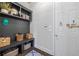 Charming mudroom with gray built-in bench, coat hooks, shelving and convenient door at 3111 Old Thompson Mill Rd, Buford, GA 30519