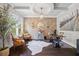 Chic office features hardwood floors, a brick accent wall, a chandelier, and a large window at 3111 Old Thompson Mill Rd, Buford, GA 30519