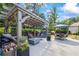 Outdoor pergola area with comfortable seating, a fire pit, and manicured landscaping at 3111 Old Thompson Mill Rd, Buford, GA 30519