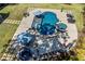 Aerial view of the backyard pool area, complete with a spa, lounging areas, and landscaping at 3111 Old Thompson Mill Rd, Buford, GA 30519