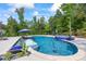 A luxurious pool and spa are surrounded by lush landscaping offering a private retreat at 3111 Old Thompson Mill Rd, Buford, GA 30519